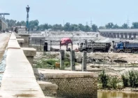 modern bridge the ongoing rehabilitation of the sukkur barrage has reached a significant milestone with successfully replacement of gates the extensive project is transforming the site characterised by bustling construction activity under a bright sunny sky photo ppi