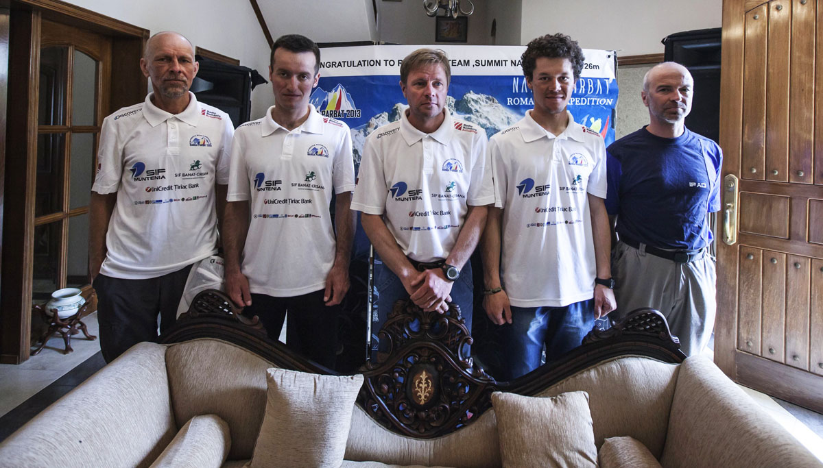 romanian climbers l r bruno adamcsek teo vlad zsolt torok aurel salasan and marius gane pose for a photograph after a news conference at the romanian embassay in islamabad photo rueters