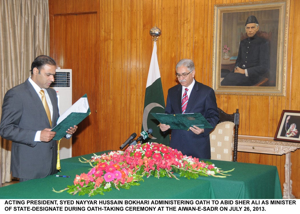 minister of state abid sher ali is administered his oath by the acting president nayyar hussain bokhari at the aiwan e sadr on friday photo pid