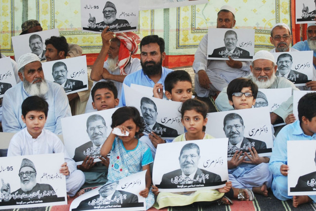 participants of a protest demonstration in sargodha hold up placards bearing the picture of ousted egyptian president mohammad mursi photo israrul haq express participants of a protest demonstration in sargodha hold up placards bearing the picture of ousted egyptian president mohammad mursi photo israrul haq express