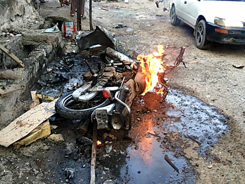 a motorcycle burns at the site of one of the blasts in parachinar photo express