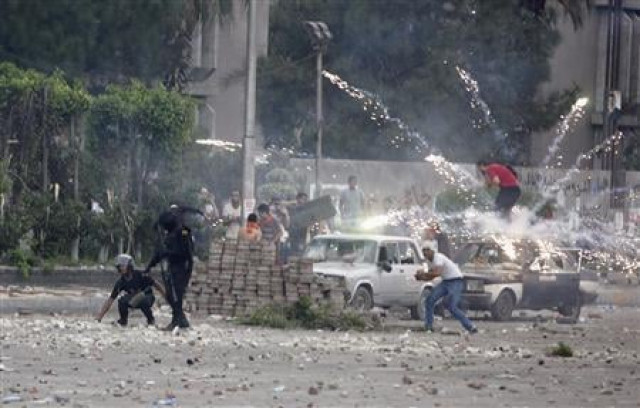 a police officer aims a shotgun at supporters of deposed egyptian president mohamed mursi during clashes in nasr city area east of cairo july 27 2013 photo reuters a police officer aims a shotgun at supporters of deposed egyptian president mohamed mursi during clashes in nasr city area east of cairo july 27 2013 photo reuters