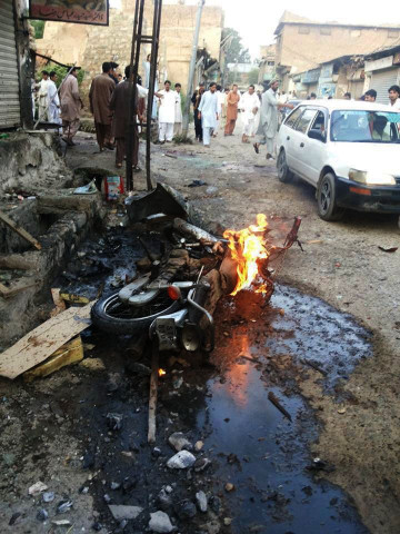people gather around one of the blast sites in parachinar on friday photo express people gather around one of the blast sites in parachinar on friday photo express