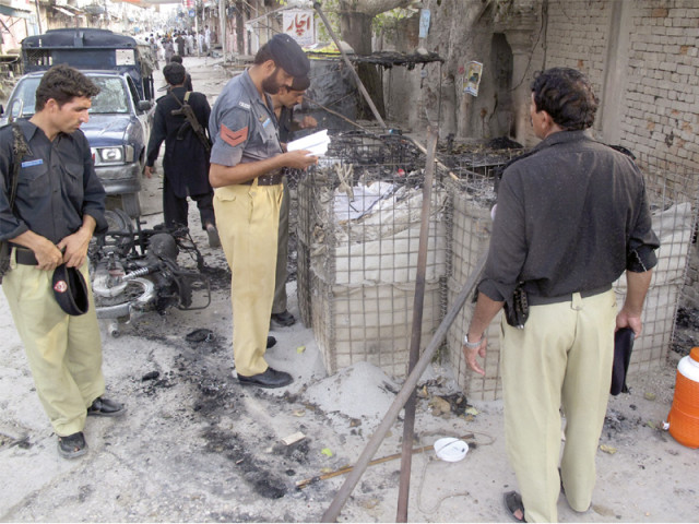 policemen collect evidence outside the site following the brazen attack photo reuters policemen collect evidence outside the site following the brazen attack photo reuters