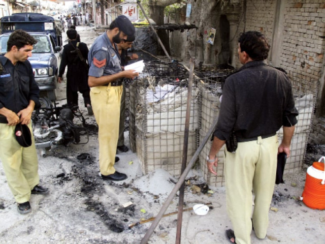policemen collect evidence outside the site following the brazen attack in di khan photo reuters policemen collect evidence outside the site following the brazen attack in di khan photo reuters