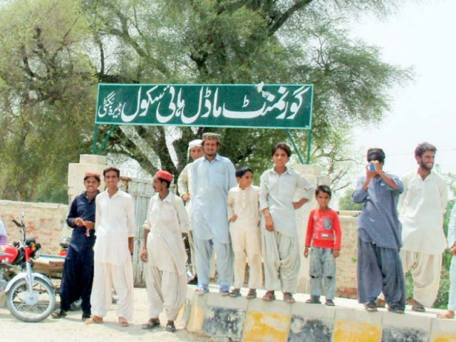 men standing outside a closed govt model school photo zahid gishkori express men standing outside a closed govt model school photo zahid gishkori express