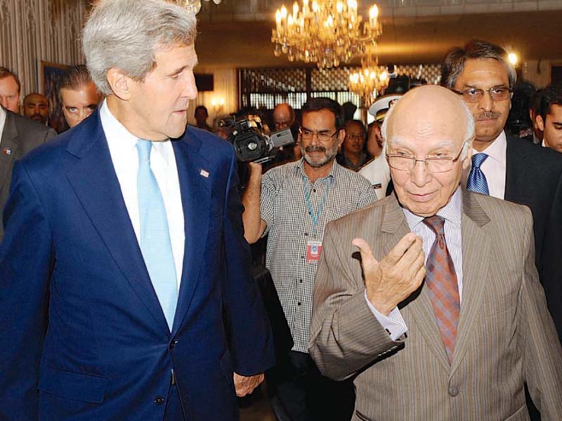 us secretary of state john kerry walks with prime minister s adviser on foreign affairs sartaj aziz before their meeting photo courtesy us state dept