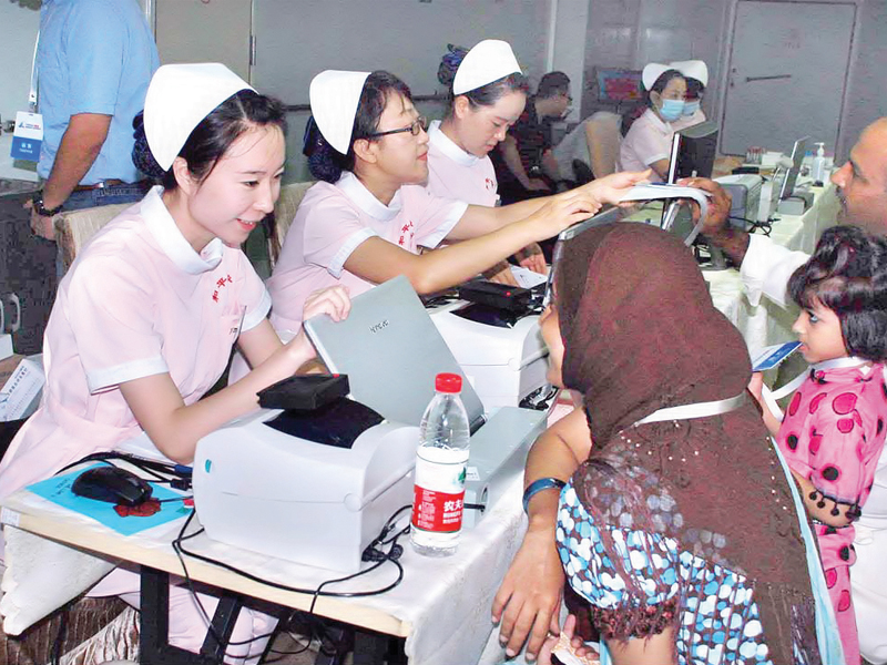 chinese medical staff perform check up on pakistani patients aboard the peace ark on friday nearly 1 800 patients have been treated on the ship since it opened its doors for the public on monday photo app