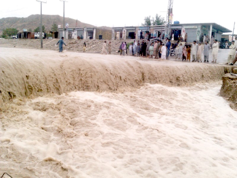 a massive torrent sweeps through a road in kalat on saturday photo express