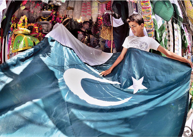 patriotic a vendor displaying national flags to attract the attention of customers ahead of eid photo app