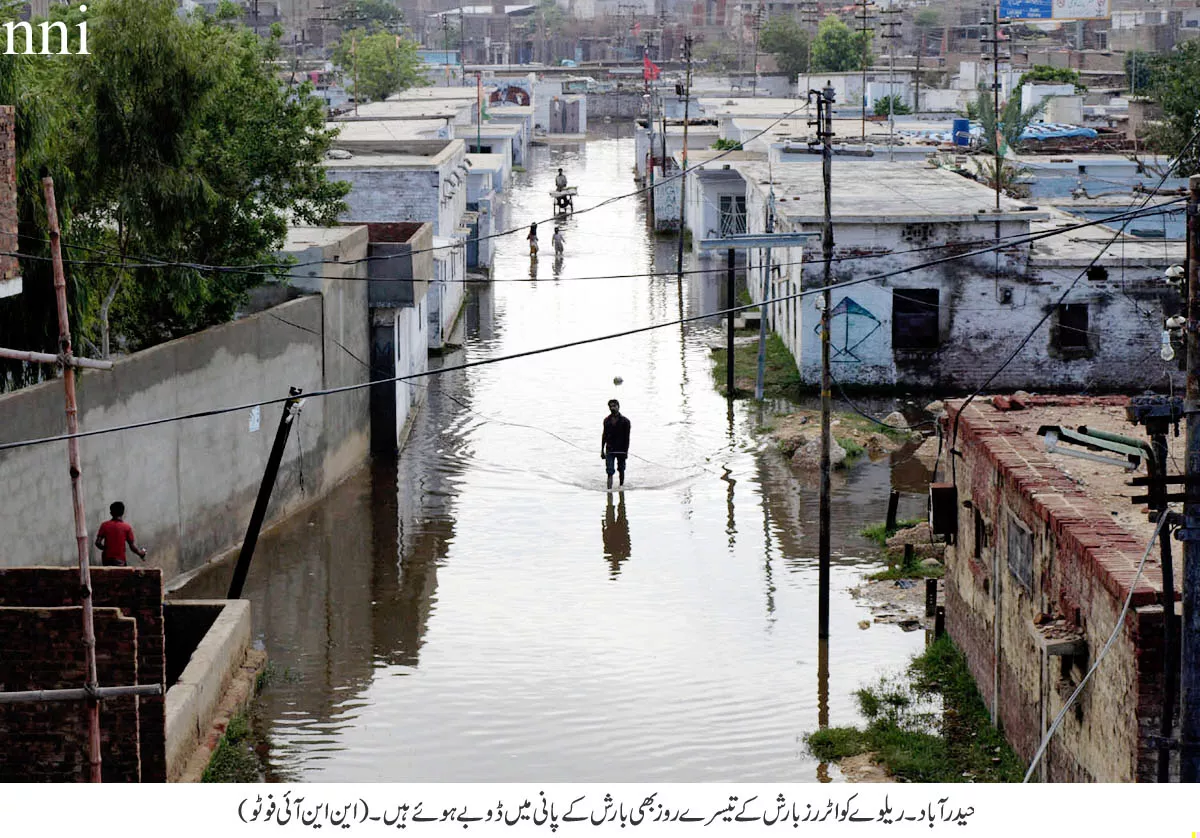 a man stands in the middle of a flooded street in hyderabad photo nni a man stands in the middle of a flooded street in hyderabad photo nni