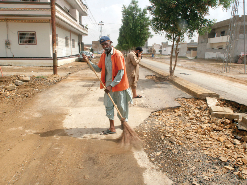 damage control municipal workers sweep the main road in saadi town two days after heavy rains lashed the city the enclosed neighbourhood of saadi town was one of the worst affected areas as water gushed down the kirthar range down to saadi town and its adjacent areas and then further down to safoora goth and pehlwan goth photo athar khan express
