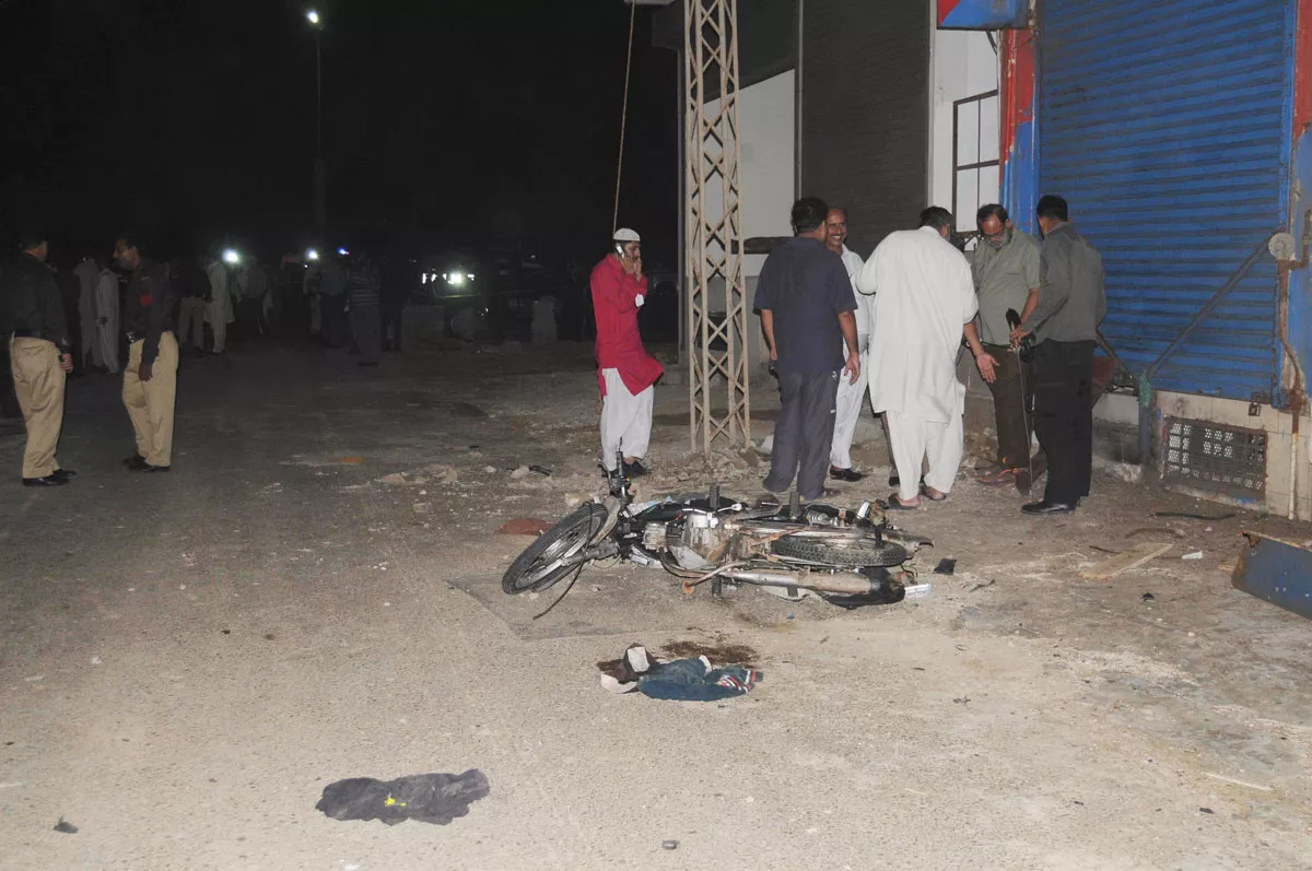 officials gather outside a liquor store on khayaban e muslim after a blast photo mohammmad noman express officials gather outside a liquor store on khayaban e muslim after a blast photo mohammmad noman express