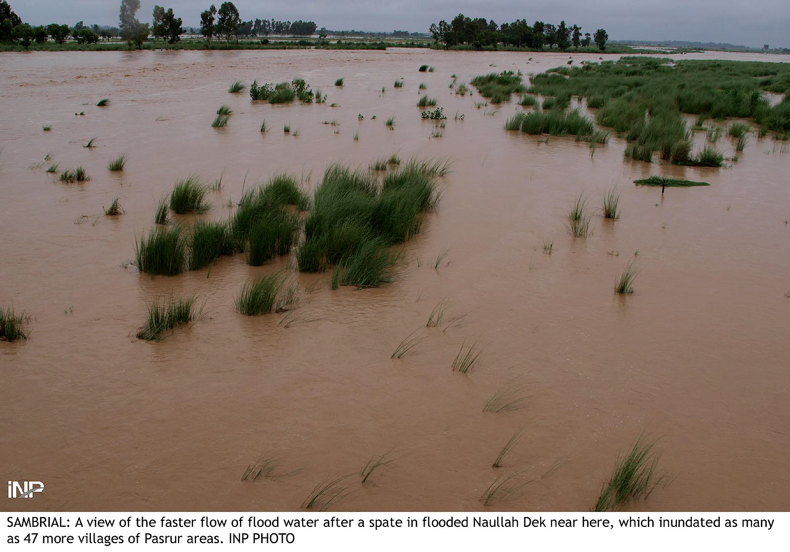 the flooded naullah dek near sambrial sialkot photo inp