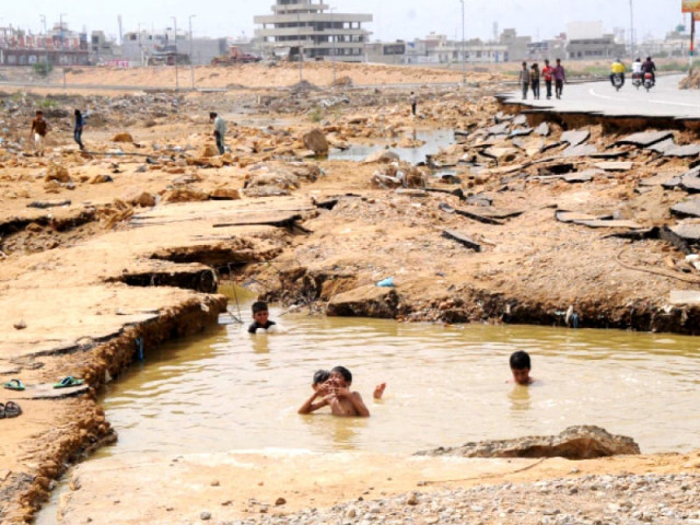 children bathe in a pool of stagnant water which accumulated after heavy rainfall in gadap town five children reportedly drowned on tuesday while swimming in malir riverbank photo rashid ajmeri express