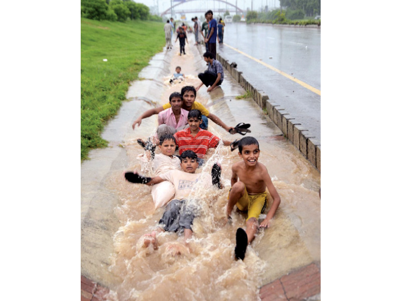 as the twin cities received their moderate share of monsoon rains young residents enjoyed the day with outdoor activities while others were either stuck in traffic jams on the inundated roads or busy pumping water out from inside their houses photo inp muhammad javaid express