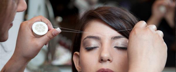 threading is a common way to shape eyebrows photo afp