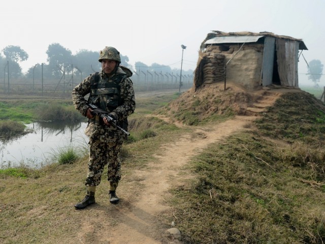 an indian border security force bsf soldier keeps watch at an outpost along the india pakistan border photo afp