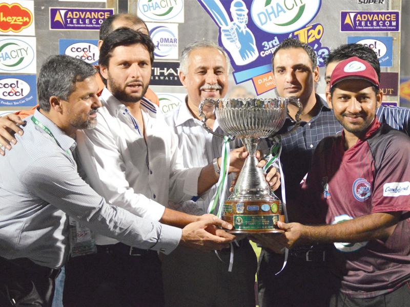 omar associates captain sarfraz ahmed was presented with the corporate t20 cup trophy by pakistan all rounder shahid afridi photo tournament organisers