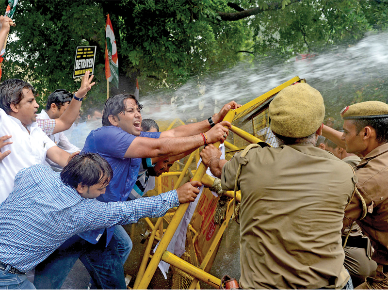 a stream of water from a police water cannon covers indian youth congress activists as they stage a violent protest near the pakistan high commission in new delhi photo afp