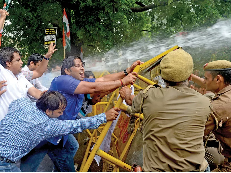 a stream of water from a police water cannon covers indian youth congress activists as they stage a violent protest near the pakistan high commission in new delhi photo afp a stream of water from a police water cannon covers indian youth congress activists as they stage a violent protest near the pakistan high commission in new delhi photo afp
