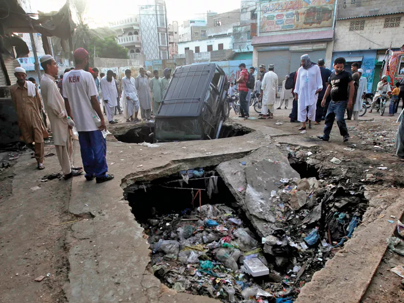 residents gather around an inverted vehicle nose dived into a trench holed as a result of the bomb explosion photo athar khan express residents gather around an inverted vehicle nose dived into a trench holed as a result of the bomb explosion photo athar khan express