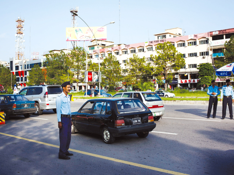 a security official screens vehicles at a check post in the capital photo myra iqbal express