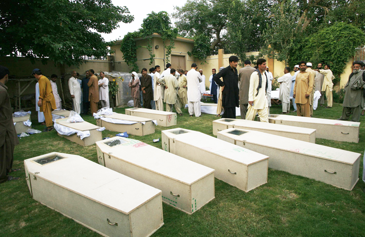 relatives and colleagues gather near the caskets of victims killed in a suicide bomb attack before funeral ceremony at a police headquarters in quetta august 8 2013 photo reuters file