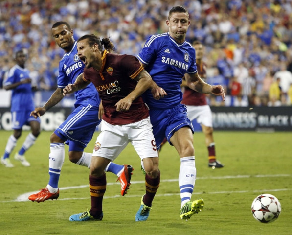 as roma 039 s pablo osvaldo reacts as he collides with chelsea defenseman gary cahill r during the second half of their friendly soccer match in washington august 10 2013 photo reuters