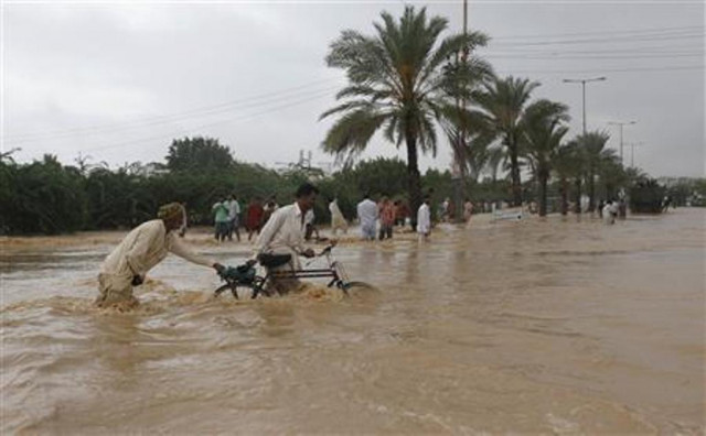 men push their bicycles through flood waters on the outskirts of karachi august 4 2013 photo reuters men push their bicycles through flood waters on the outskirts of karachi august 4 2013 photo reuters