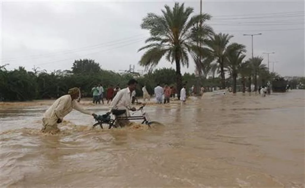 men push their bicycles through flood waters on the outskirts of karachi august 4 2013 photo reuters men push their bicycles through flood waters on the outskirts of karachi august 4 2013 photo reuters