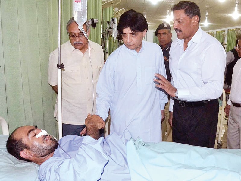 interior minister chaudhry nisar inquires after the health of police lines blast victim at cmh photo app