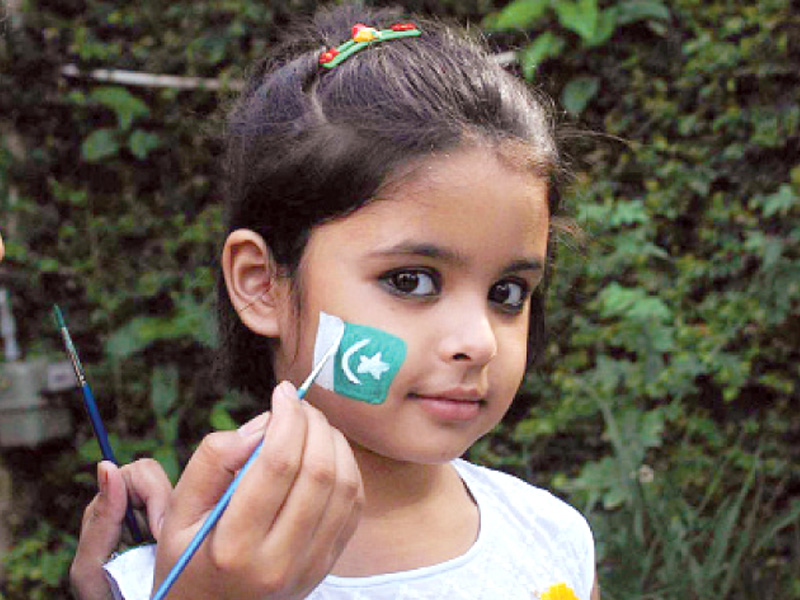 a young girl gets a flag painted on her cheek photo waseem imran express online