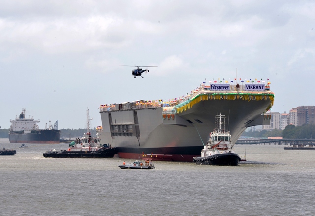 tugboats guide the indigenously built aircraft carrier ins vikrant as it leaves the cochin shipyard limited 039 s dock after its launch in kochi on august 12 2013 photo afp