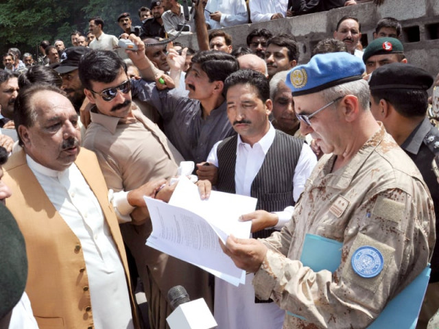 azad jammu and kashmir s prime minister chaudhry abdul majeed hands a memorandum to un officials in muzaffarabad photo afp azad jammu and kashmir s prime minister chaudhry abdul majeed hands a memorandum to un officials in muzaffarabad photo afp