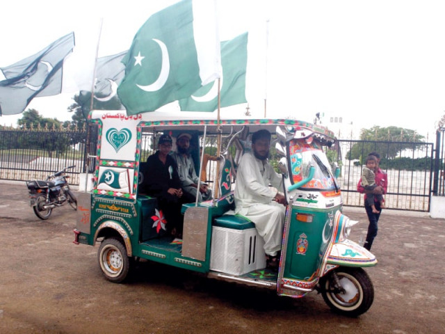 a rickshaw decorated with national colours and flags drives past the mausoleum of the founder of nation quaid azam photo athar khan tribune a rickshaw decorated with national colours and flags drives past the mausoleum of the founder of nation quaid azam photo athar khan tribune