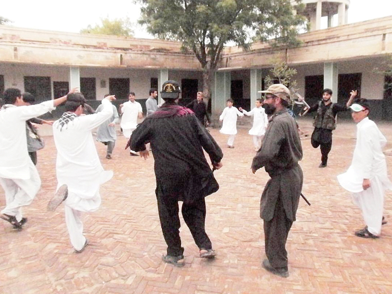 levies force personnel dance with children during a ceremony on independence day in south waziristan photo online