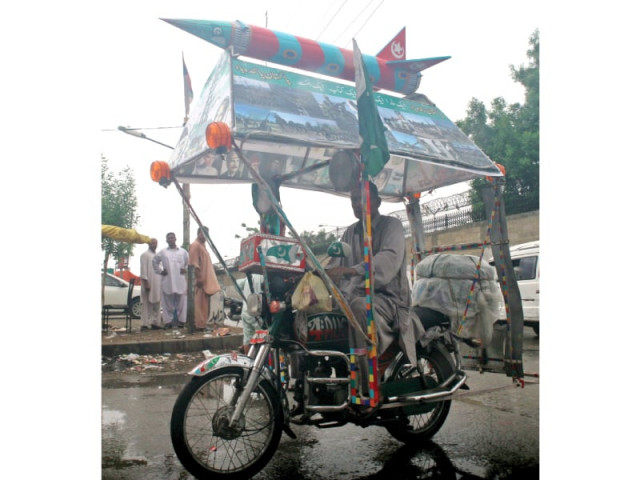 lala pakistani with his decorated bike carrying pictures of martyred army personnel and a model of ghauri missile photo athar khan express lala pakistani with his decorated bike carrying pictures of martyred army personnel and a model of ghauri missile photo athar khan express