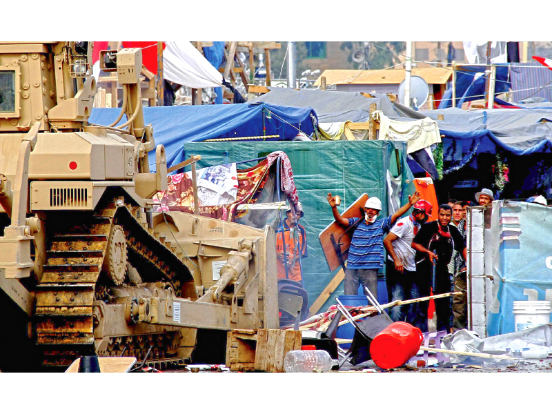 a security forces bulldozer moves in to smash a protest camp photo afp