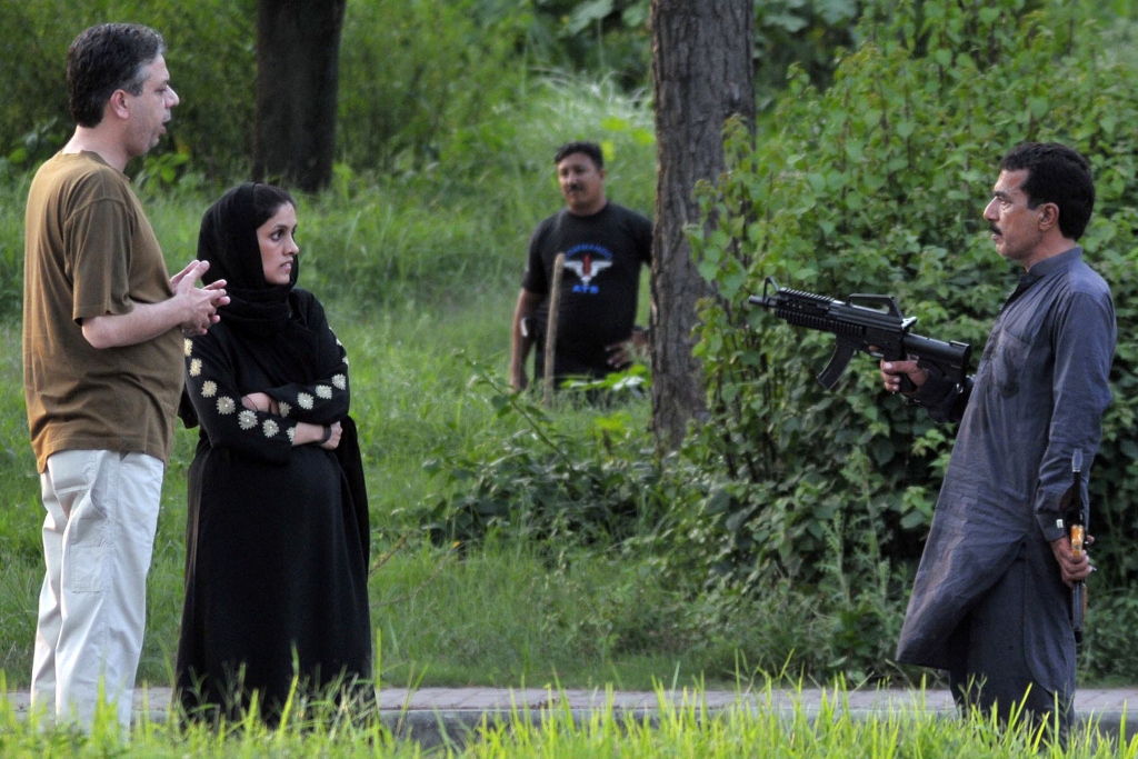 sikandar hayat is seen pointing a gun his wife kanwal and ssp operations dr rizwan are seen negotiating photo express