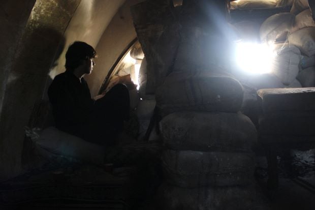 a free syrian army fighter takes cover inside a house in the bab al nasr neighborhood of aleppo august 14 2013 reuters melhem barakat