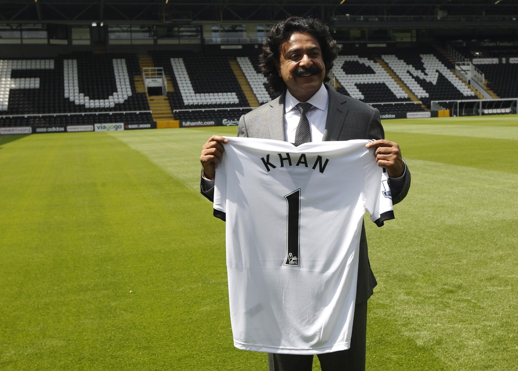 the new owner of fulham football club shahid khan holds a personalised team shirt as he poses for photographers at the club 039 s craven cottage ground in west london july 13 2013 photo reuters