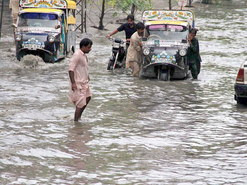 citizens battle through the rainwater on the roads of hyderabad photo online