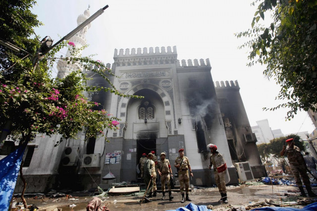 members of the military police stand outside the burnt rabaa adawiya mosque the morning after the clearing of a protest which was held around the mosque in cairo photo reuters members of the military police stand outside the burnt rabaa adawiya mosque the morning after the clearing of a protest which was held around the mosque in cairo photo reuters