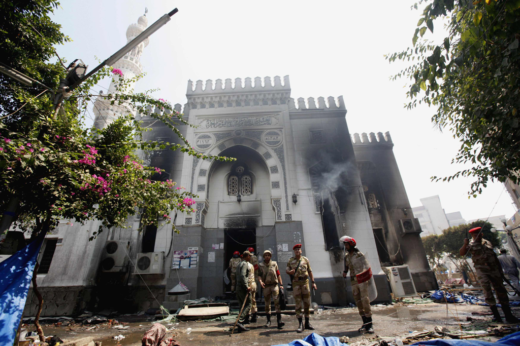 members of the military police stand outside the burnt rabaa adawiya mosque the morning after the clearing of a protest which was held around the mosque in cairo photo reuters