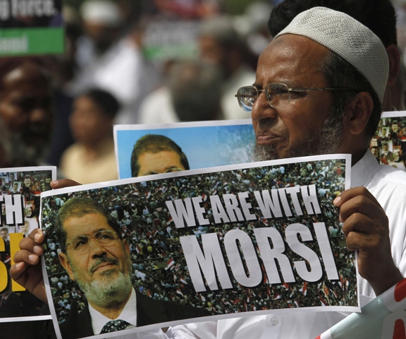 a supporter of jamaat e islami holds a poster in favor of ousted egyptian president mohamed mursi during a rally in karachi august 16 2013 photo reuters