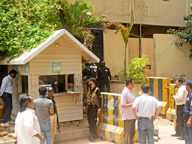 express media employees and security personnel gather at the entrance of the office after the attack photo express