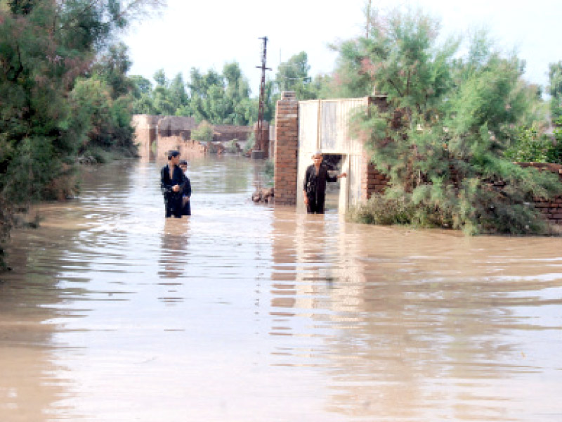 budhni stream overflowing on charsadda road in peshawar residents in chitral have warned of sit ins if relief is not provided in the province soon photo express