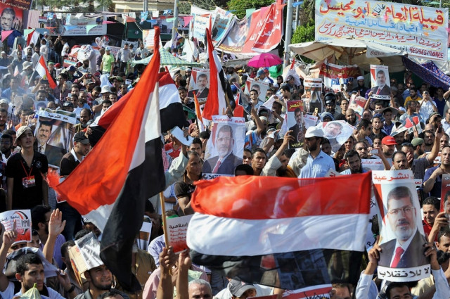 egyptian supporters of deposed president mohamed morsi raise up portraits of him and national flags during a demonstration in morsi 039 s support near cairo university egypt on july 26 2013 photo afp file egyptian supporters of deposed president mohamed morsi raise up portraits of him and national flags during a demonstration in morsi 039 s support near cairo university egypt on july 26 2013 photo afp file