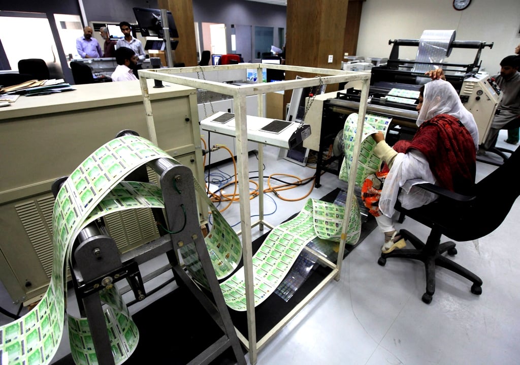 a worker of the national database and registration authority nadra checks newly printed government identity cards of registered citizens at the nadra head office in islamabad november 14 2012 photo file